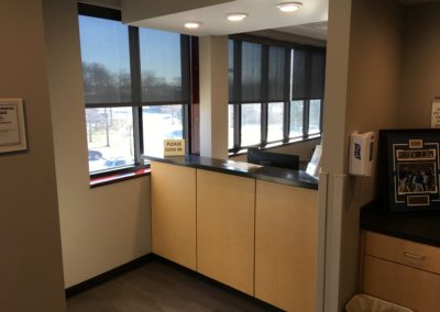 Wooden cabinets and receptionists desk installed by MAC in Kansas City