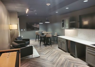 Dark wood cabinets in an office breakroom and silver appliances