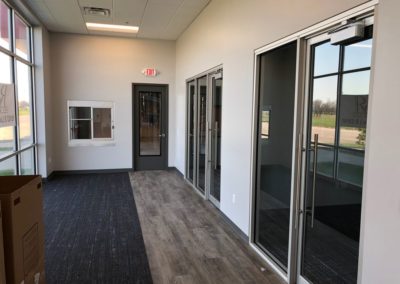 Office glass doors installed by MAC with custom wood flooring in Kansas City