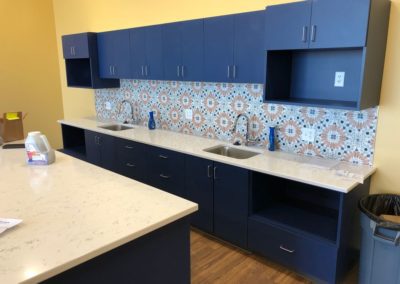 Dark blue cabinets with white countertops