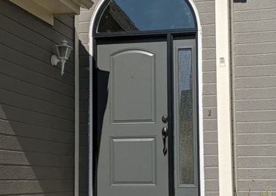 Gray residential door with frost glass accents