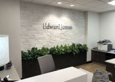 Entrance to Edward Jones with custom stone siding in a modern office design by MAC in Kansas City