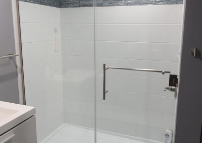 Glass shower with custom white tiling installed by MAC in Kansas City