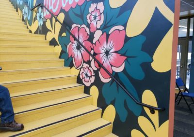 Floral painted stairway with black railing created by MAC in Kansas City