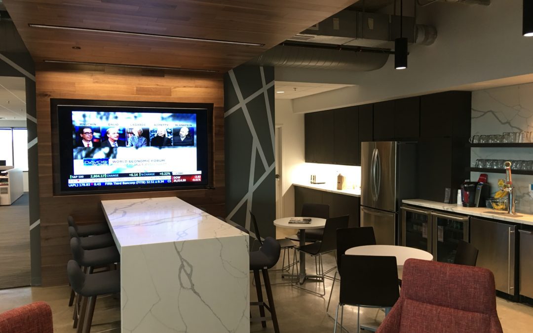 Break room with furniture, tables, and a TV in Kansas City, designed by MAC